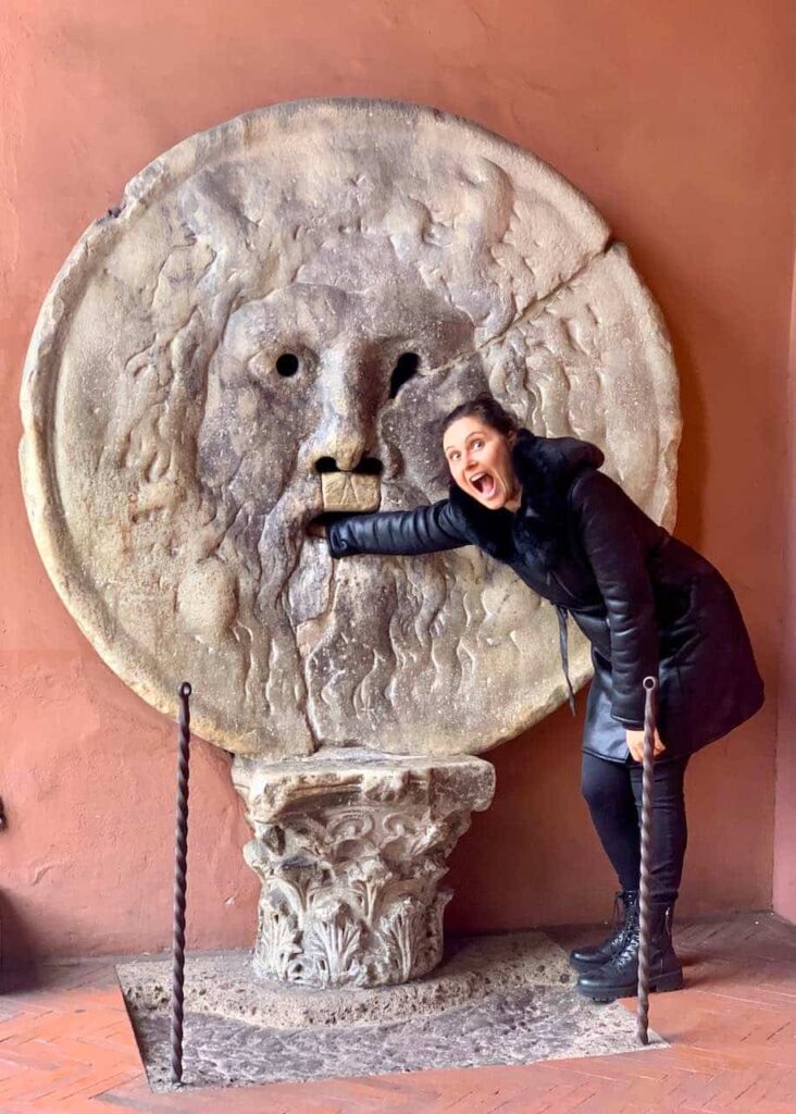 Milijana Gabrić of the Go Travel Italy Now website with the Mouth of the Truth in Rome Italy. Putting your hand into it is one of the most iconic things to do in Rome. 