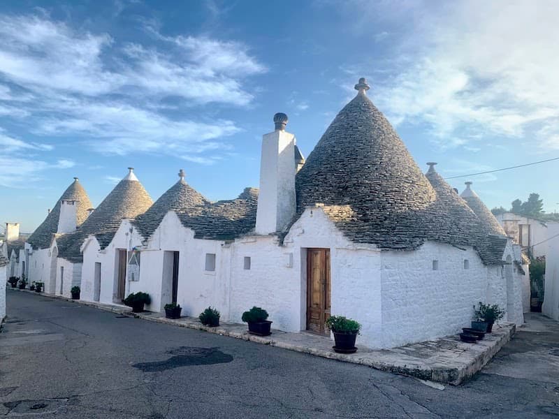 I Drove All Over Puglia, Italy — Here Are 6 Road Trip Itineraries That Actually Work Traditional trulli houses with conical stone roofs in Alberobello, Puglia, Italy.