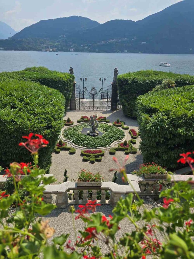 the formal gardens and fountain of Villa Carlotta in Tremezzo, showcasing stunning views of Lake Como