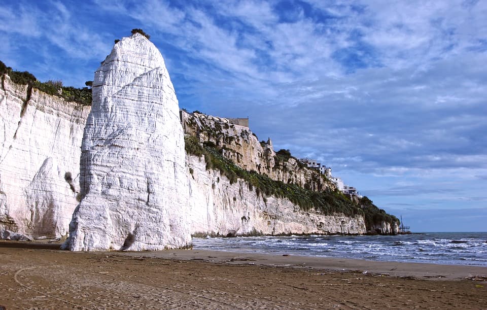 I Drove All Over Puglia, Italy — Here Are 6 Road Trip Itineraries That Actually Work The Pizzomunno sea stack rising from the beach in Vieste, Puglia, Italy.