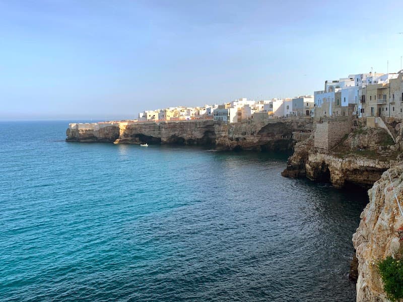 I Drove All Over Puglia, Italy — Here Are 6 Road Trip Itineraries That Actually Work Rocky coastline and historic white houses overlooking the Adriatic Sea in Polignano a Mare, Puglia, Italy.