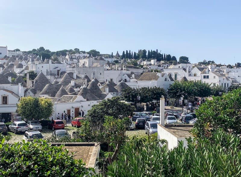 Famous town of Alberobello in Puglia, Italy, with white stone houses and cone-shaped roofs