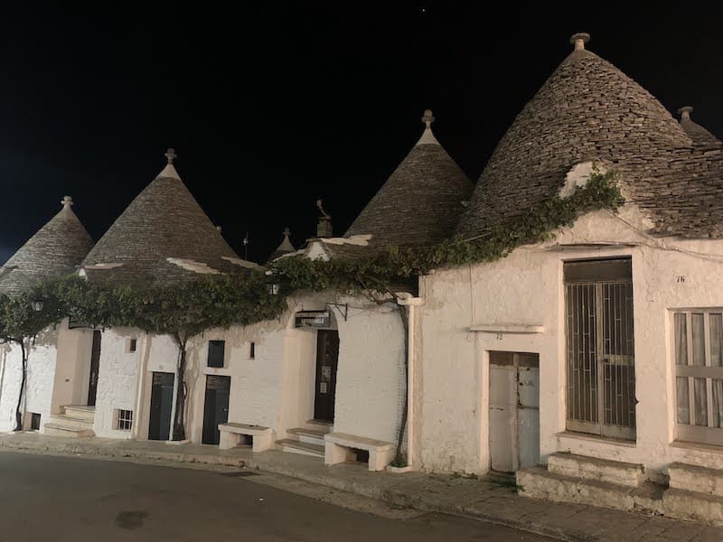 Trulli houses lit up at night in Alberobello, Puglia, Italy