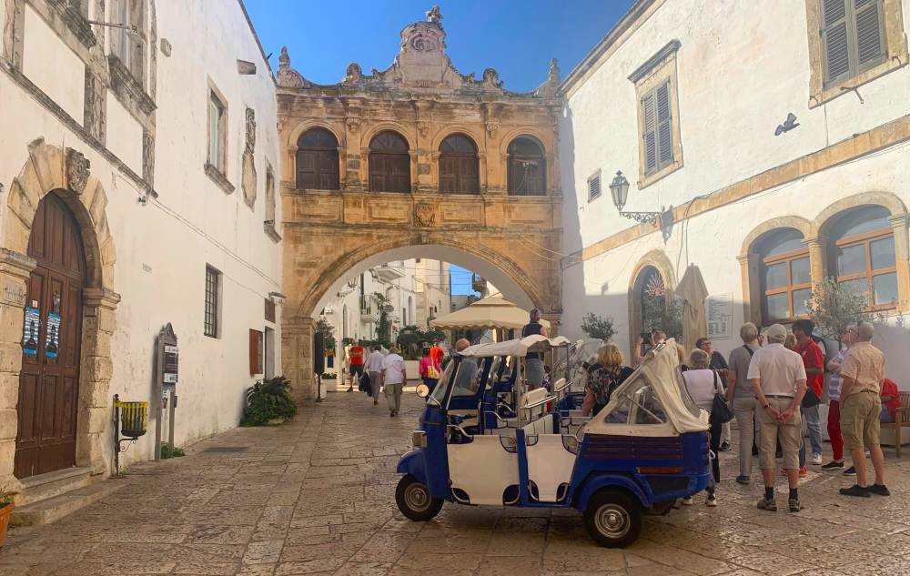 Historic Arco Scoppa stone arch in the old town of Ostuni, the White City, Puglia, Italy