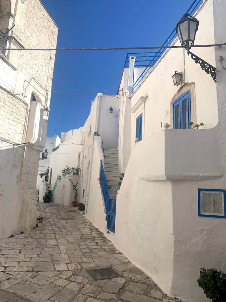 Stone-paved alley in Ostuni old town historic center, Puglia Italy