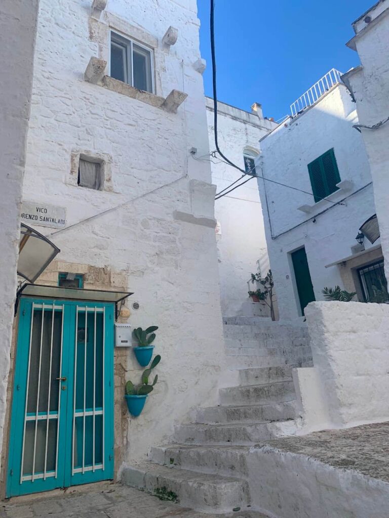 Narrow alley on Vico Lorenzo Santalari in the historic center of Ostuni, Italy, the White City of Puglia.