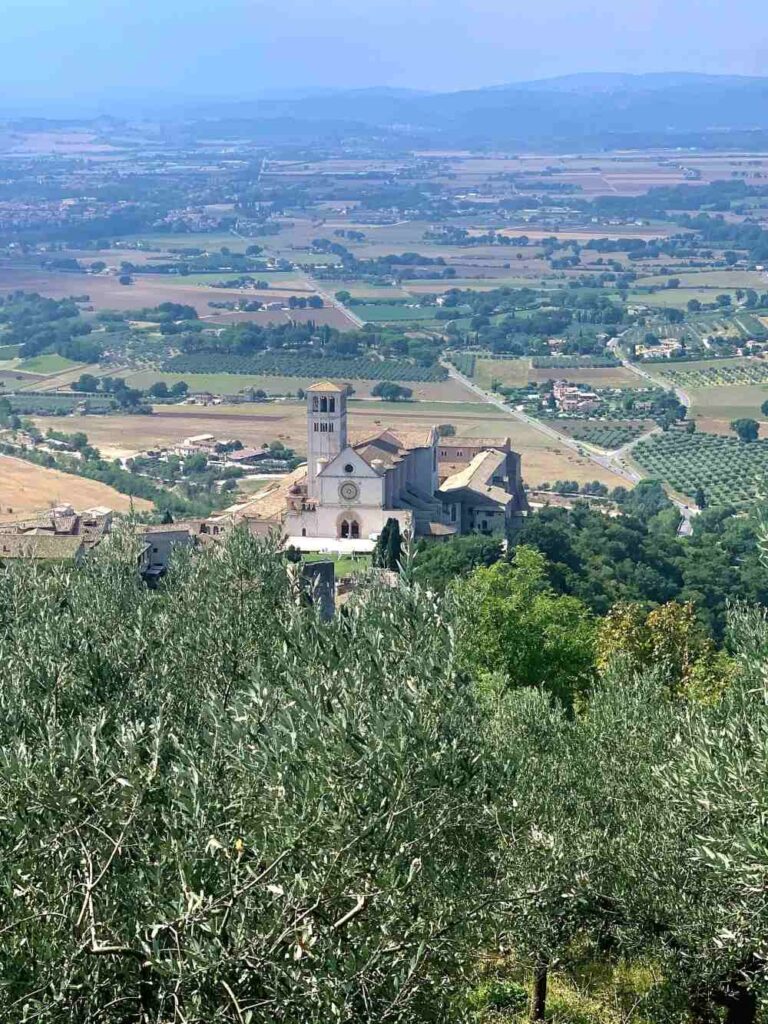 Basilica of Saint Francis nestled into the hillside in Assisi, Italy
