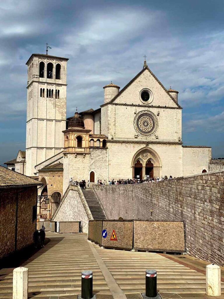 Upper facade and bell tower of the Basilica of Saint Francis of Assisi in Assisi, Italy
