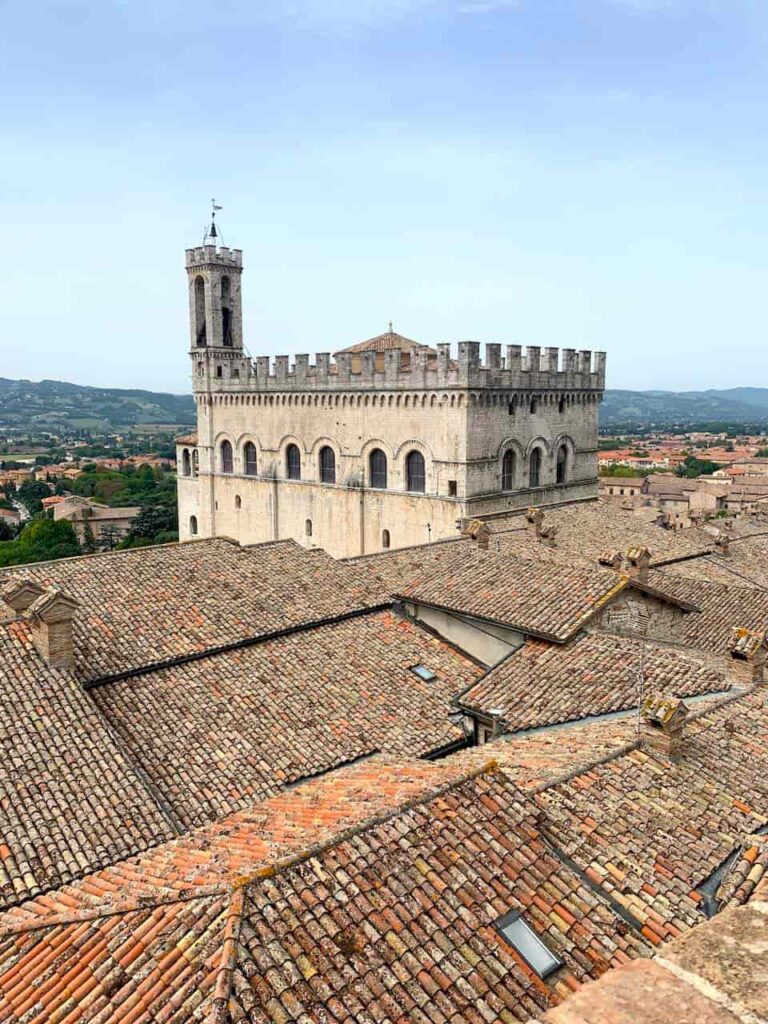 Palazzo dei Consoli rising above the terracotta rooftops of medieval Gubbio in Umbria, Italy