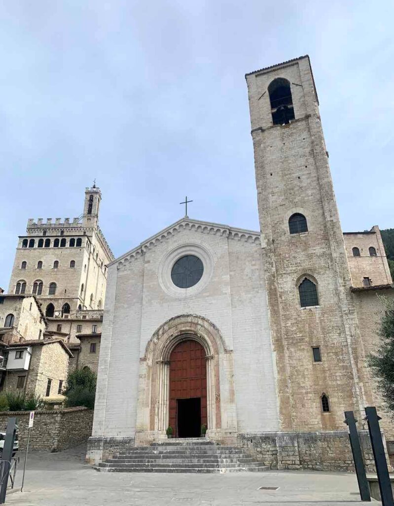 Romanesque-Gothic Church of San Giovanni Battista in Gubbio, Italy, with the tower of the Palazzo dei Consoli behind it